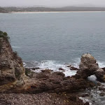 Arched rock with Pambula Beach in background