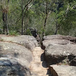 Track passing through cleft in rock