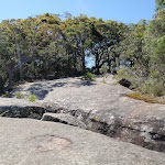 An unfenced rock slab beside the trail