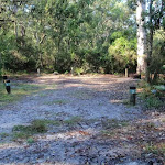 Open sandy area, numbered campsites