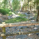 Dry rocky creek bed with timber barrier in Carnley Ave Reserve