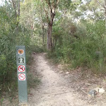 Signpost beside track