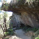 Following the track under a shallow rock overhang